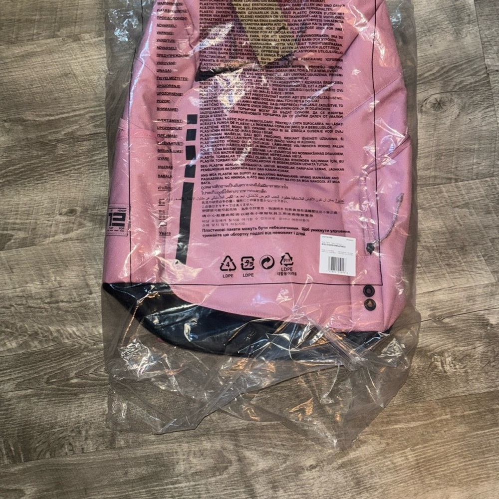 Trendy pink backpack featuring sleek black accents. Ideal for daily adventures